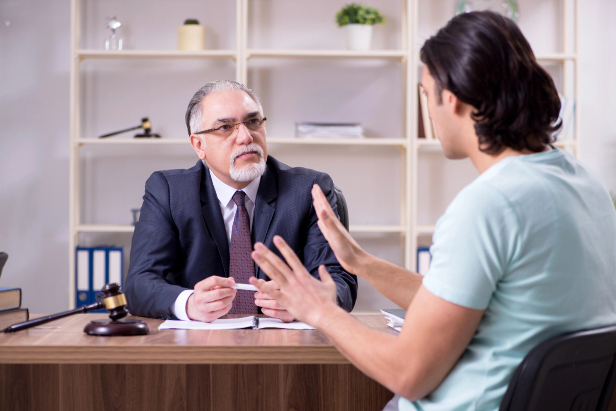 The young man visiting experienced male lawyer The young man visiting experienced male lawyer